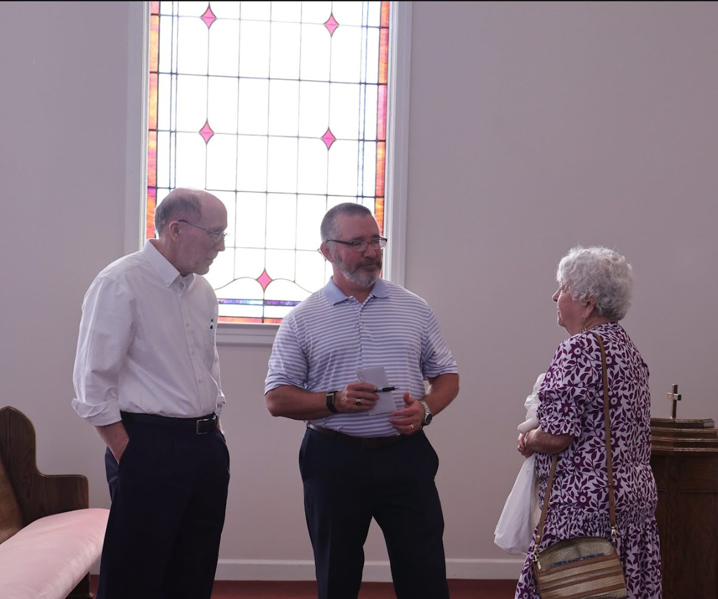Members of Norris Hill talking together in the sanctuary after a Sunday service